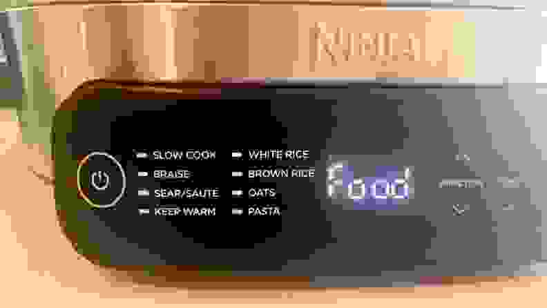 Close-up view of the The various cooking settings on the touch panel of the Ninja Foodi PossibleCooker Slow Cooker and it's small display window that read 