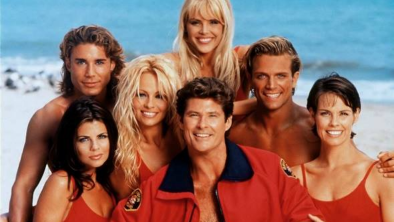 The cast of Baywatch in front of a beach