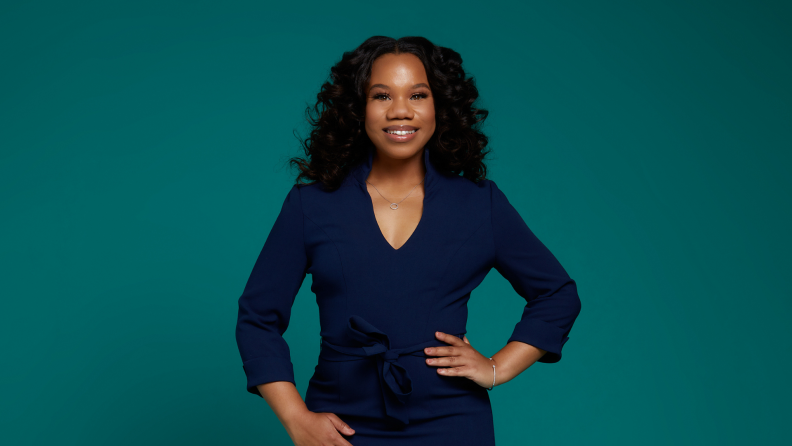 Dominique Fluker stands with her hands on her hips