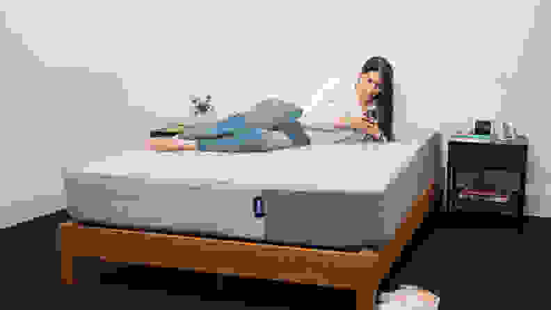 a person sits on the casper original mattress