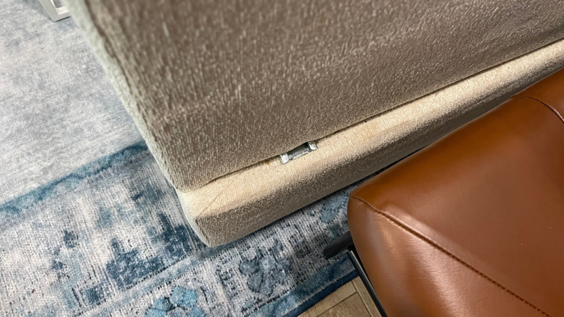 Exposed metal brackets on the side of the Kova Sofa