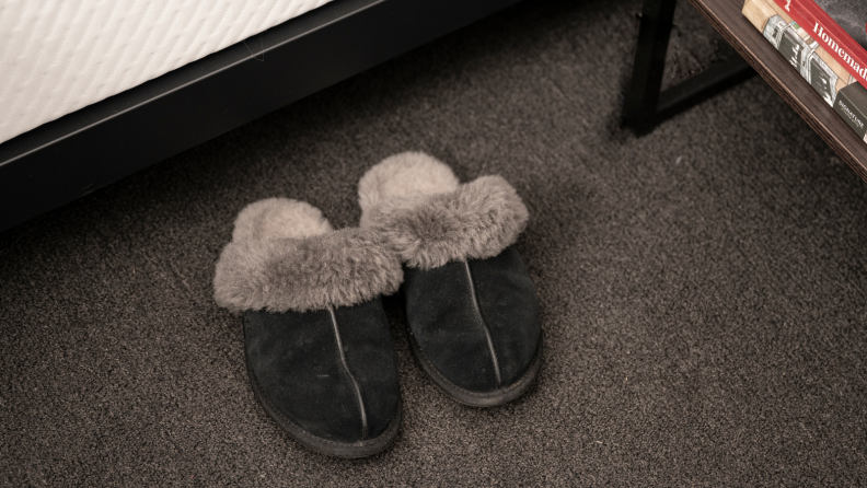 Slippers sitting by a bed.