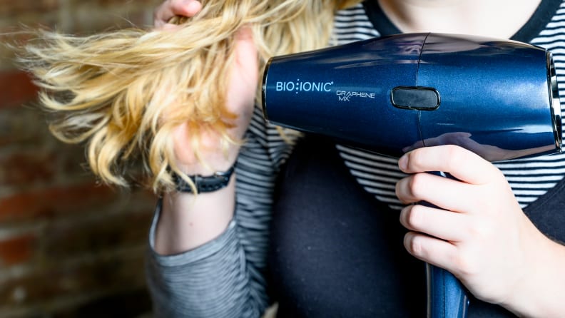 Person using a Bio Ionic hair dryer