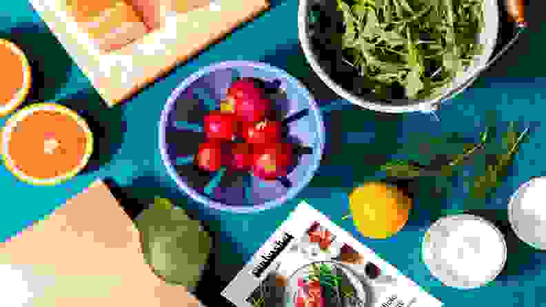 A spread of fresh produce ingredients from Sunbasket on a colorful backdrop