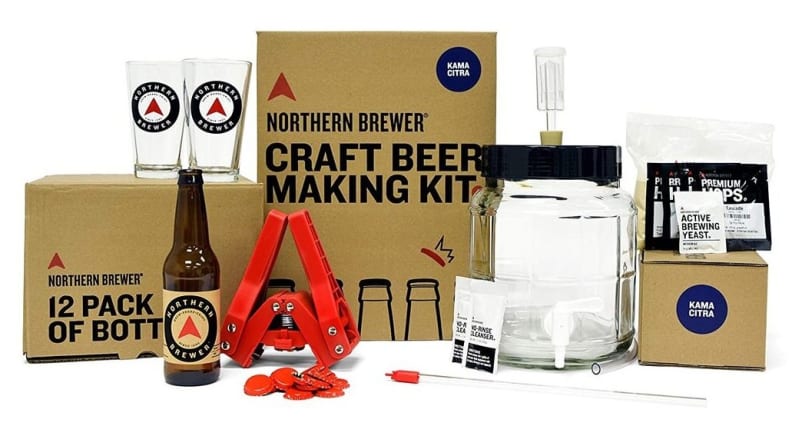 Boxes next to dark-colored beer bottle and clear glasses.