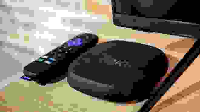 Roku streaming device next to remote.