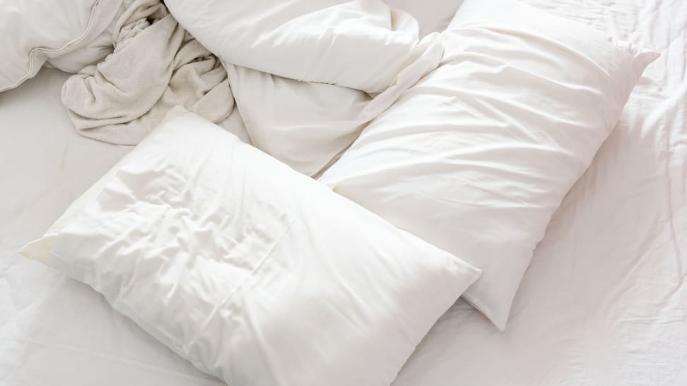 White bed sheets and pillows in white pillowcases