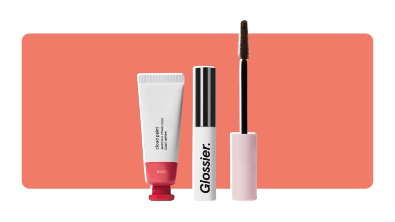 A Glossier makeup set which includes a tube of Boy Brow, Cloud Paint, and Lash Slick.