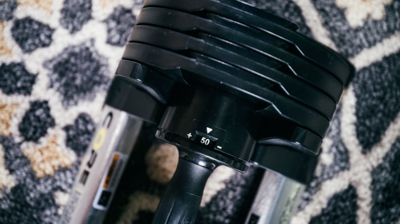 A close-up of a Core Home Fitness adjustable dumbbell