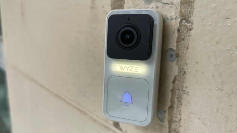 The Wyze Video Doorbell hanging near a front door.