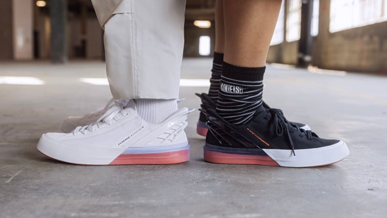 Two people wear Converse Fly Ease sneakers.
