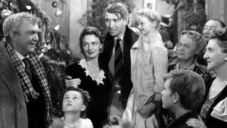 George Bailey (James Stewart) is surrounded by family and friends in the heartwarming 1946 classic It's a Wonderful Life
