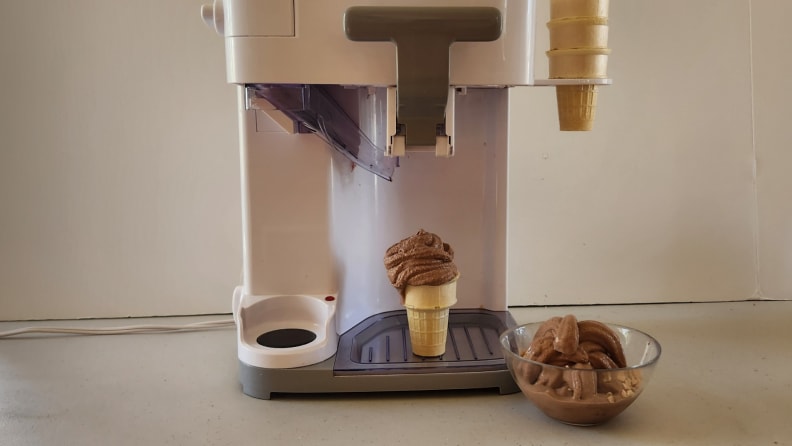 The Cuisinart Mix It In ICE-48 on a countertop surface with a chocolate soft-serve cone under dispenser.