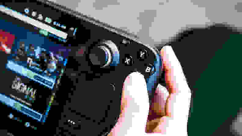 Fingers resting on a gaming device's buttons