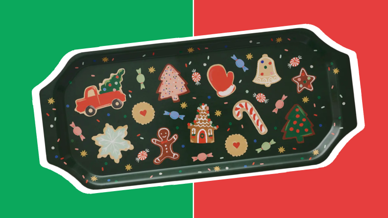 A hunter green, oblong cookie platter with festive prints in front of red and green collage.