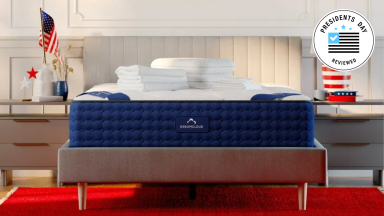 A DreamCloud mattress with a Presidents Day badge in the upper right corner.