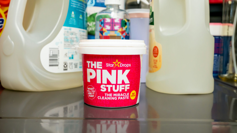 Star Drops The Pink Stuff paste appears next to detergents on a shelf.