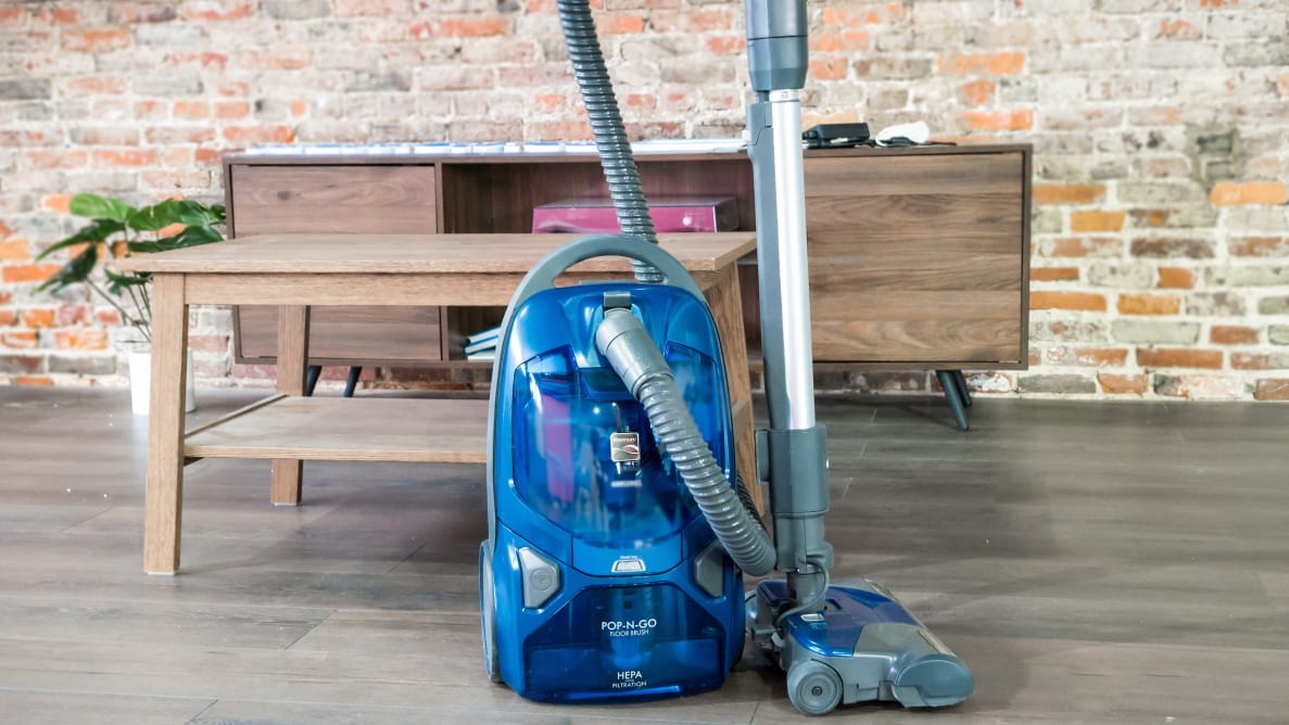 The Kenmore BC4026 canister vacuum in blue on a brick background.