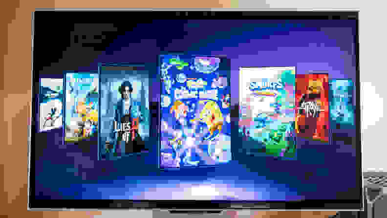 A 3D monitor stands on a desk with video games on its screen
