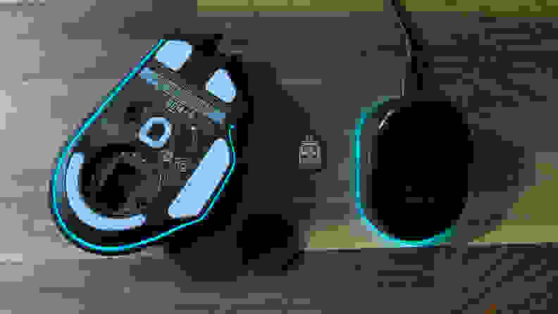 The bottom part of the mouse next to the wireless dongle and USB stick.