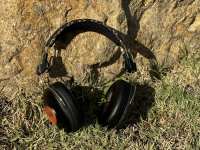 Marley Positive Vibration Frequency Headphones against a rock, outside.