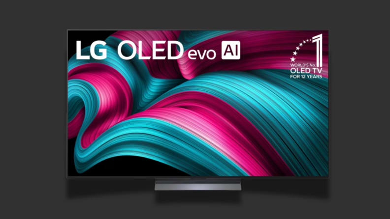 A TV with a colorful screen sits on a black background