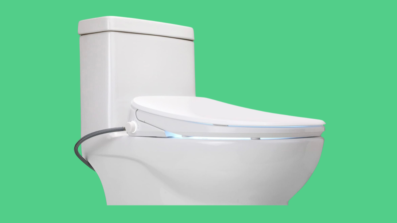 A bidet on a toilet appears on a green background.