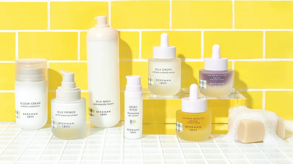 skincare products in front of yellow brick wall