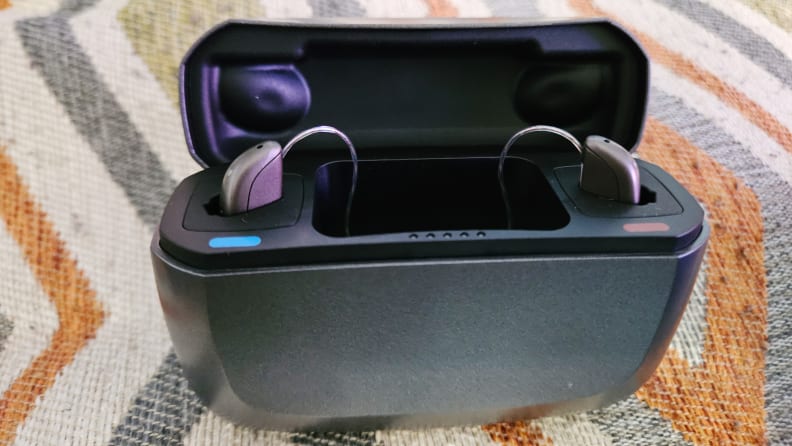 Black Jabra Enhance Select 500 hearing aid case with hearing aids inserted