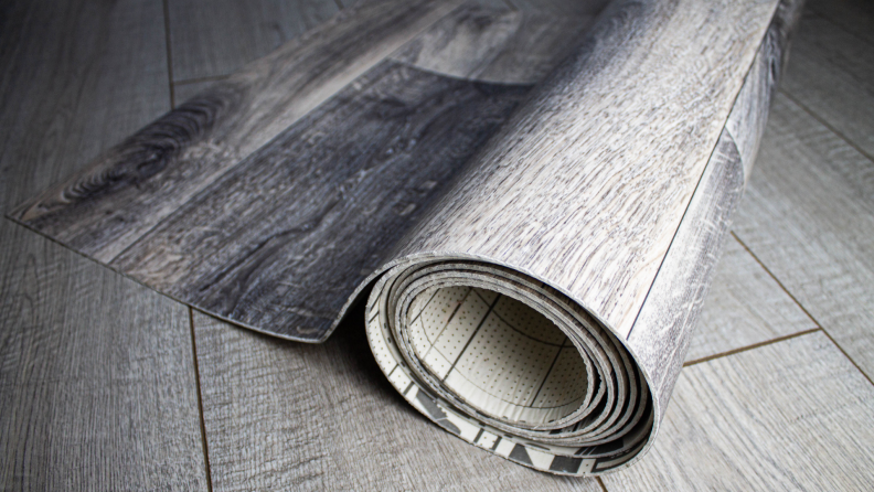 A roll of linoleum on a floor.