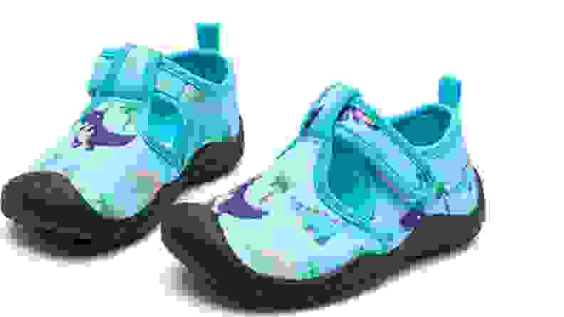 Blue water shoes with purple dinosaurs
