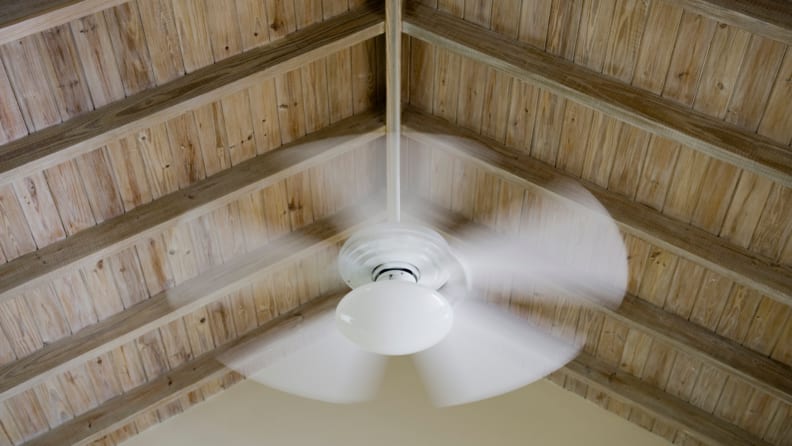 Ceiling fan rotates in motion.