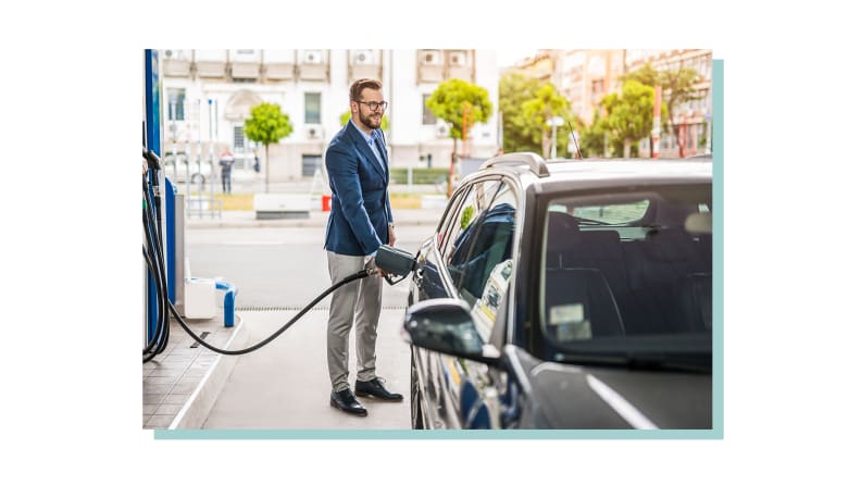 A man fueling his car at a gas station.