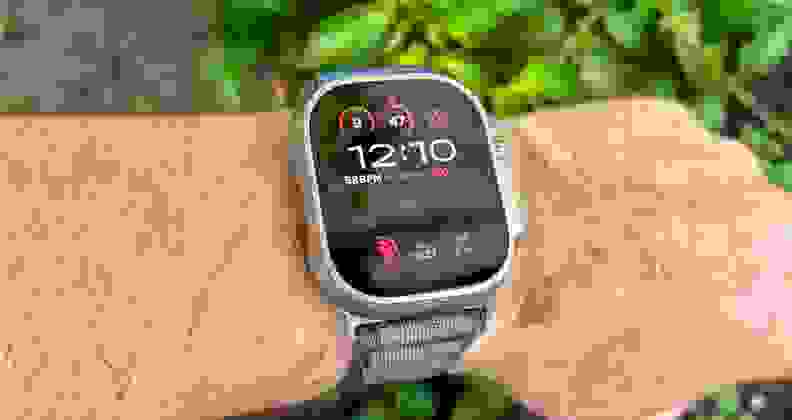 The Ultra 2 being worn by a dirty-looking explorer. It's face is visible under direct sunlight.
