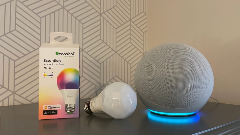 An Amazon Echo speaker sits next to a Matter-enabled Nanoleaf smart bulb and its packaging