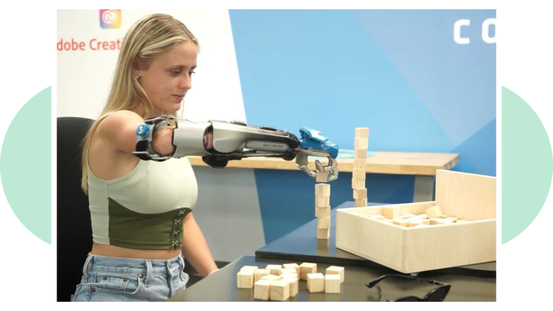 A person with a bionic arm from Limbitless Solutions works with blocks to get used to bond with the prosthetics.