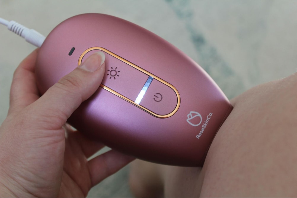 The RoseSkinCo Lumi permanent hair removal device being used on someone’s leg.