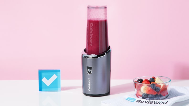 The Cuisinart Evolution X blender sits on a white surface against a pink background.