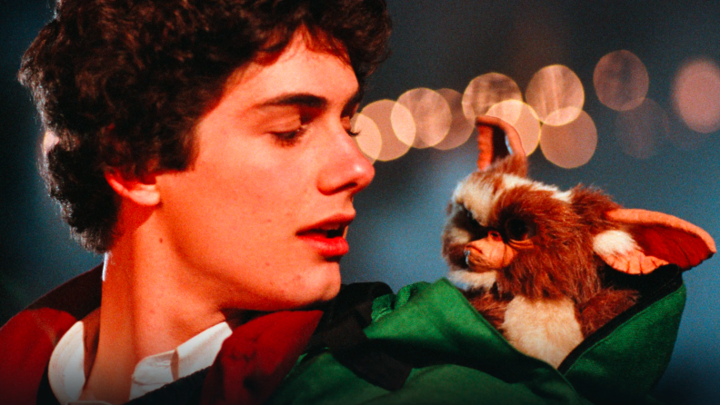 In 1984's Gremlins movie, a young Billy Peltzer (Zach Galligan) looks back at the scruffy Gremlin named Gizmo, which sits in his green backpack.