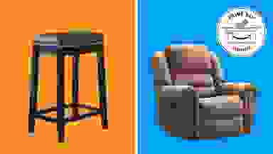 Black barstool and brown recliner in front of orange and blue background