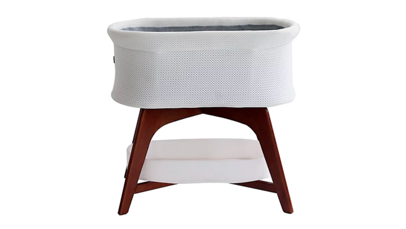 An image of a white and mahogany bassinet.