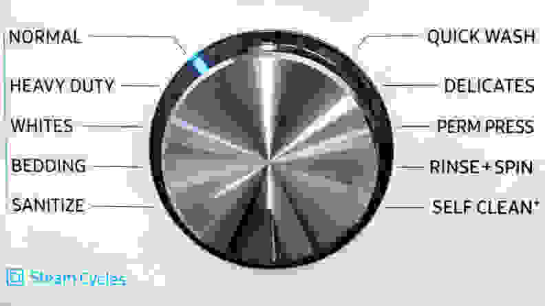 The plain, metallic control dial on the Samsung WF45R6100AW washer. Arranged around it are all the different cycles you can select.