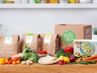 A collection of HelloFresh meal kits and vegetables in a kitchen setup.