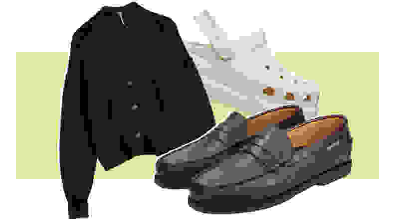 A black cardigan, a pair of brown leather loafers, and a white Croc clog.