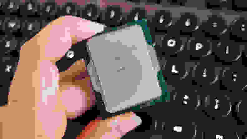 A hand holding a desktop computer processor