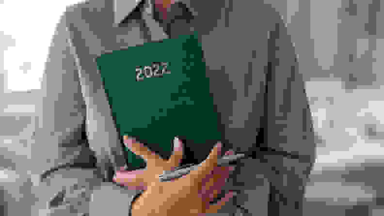 A woman holding a 2022 journal.