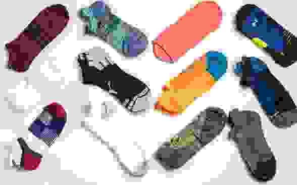 An array of unisex running socks from brands like Nike, Puma, and Saucony.