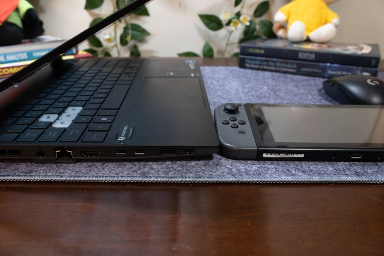 Side by side comparison of the thickness between a laptop and a handheld gaming console