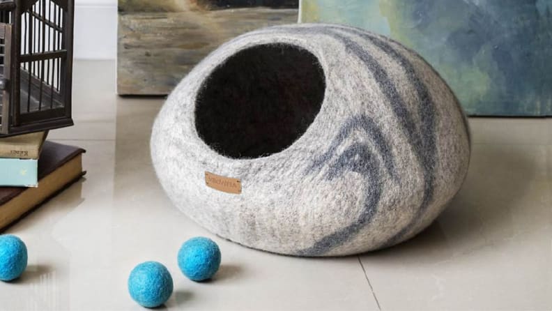 the meowfia cat cave bed in a room