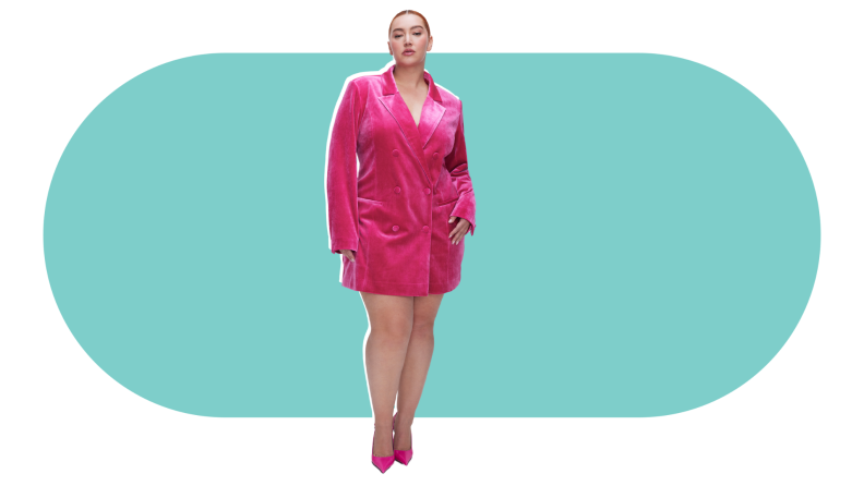 A model wearing a double-breasted pink velvet blazer dress.
